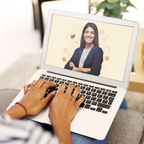 Woman’s hands typing on laptop keyboard, laptop screen features Lussier IQ content. 