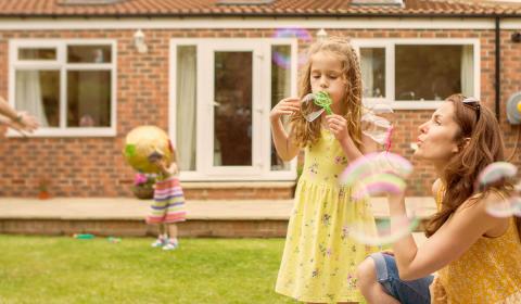 Girls playing in front of their house