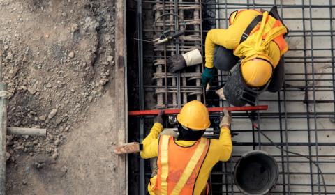 Two construction workers on construction site