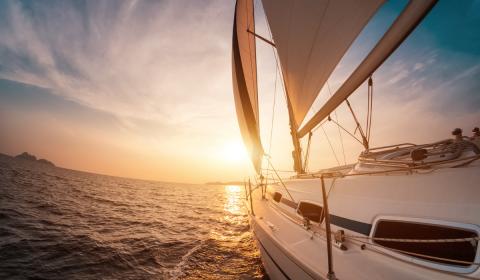 side of sailboat in the ocean sunset