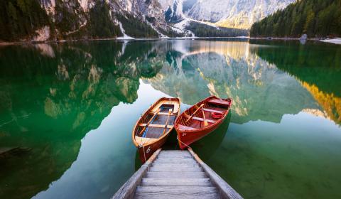 2 boats by the dock in the water